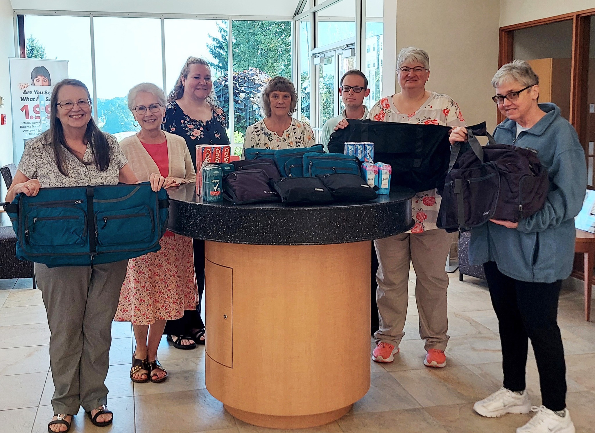 Photo of IUCU employees with duffel bags ready for donation
