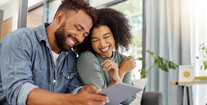 Photo of a couple using a tablet device